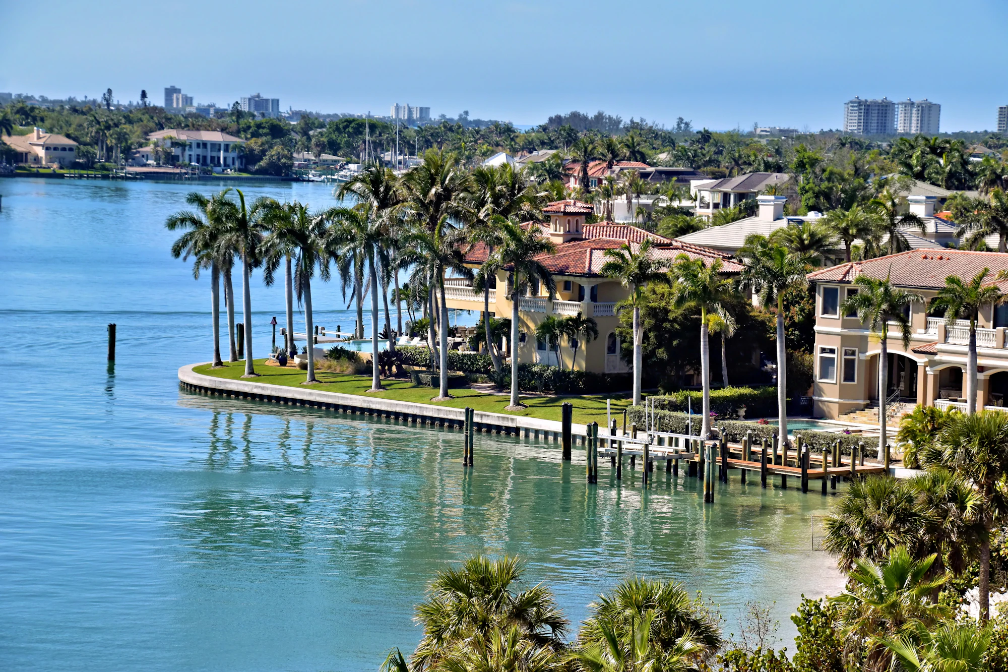 Waterfront homes with palm trees along a Florida canal