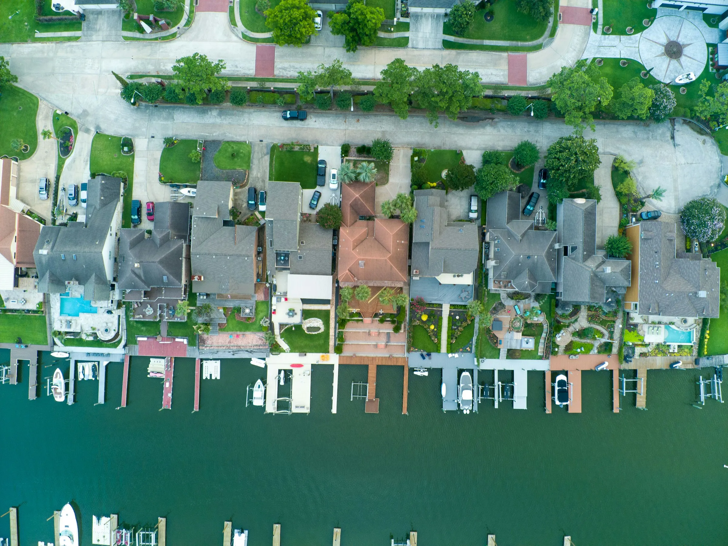 Aerial view of canal-front homes with docks and boat lifts