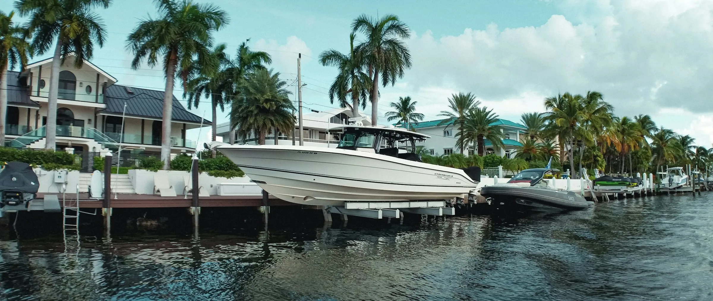 Boat raised on a boat lift at a residential dock on a Florida canal