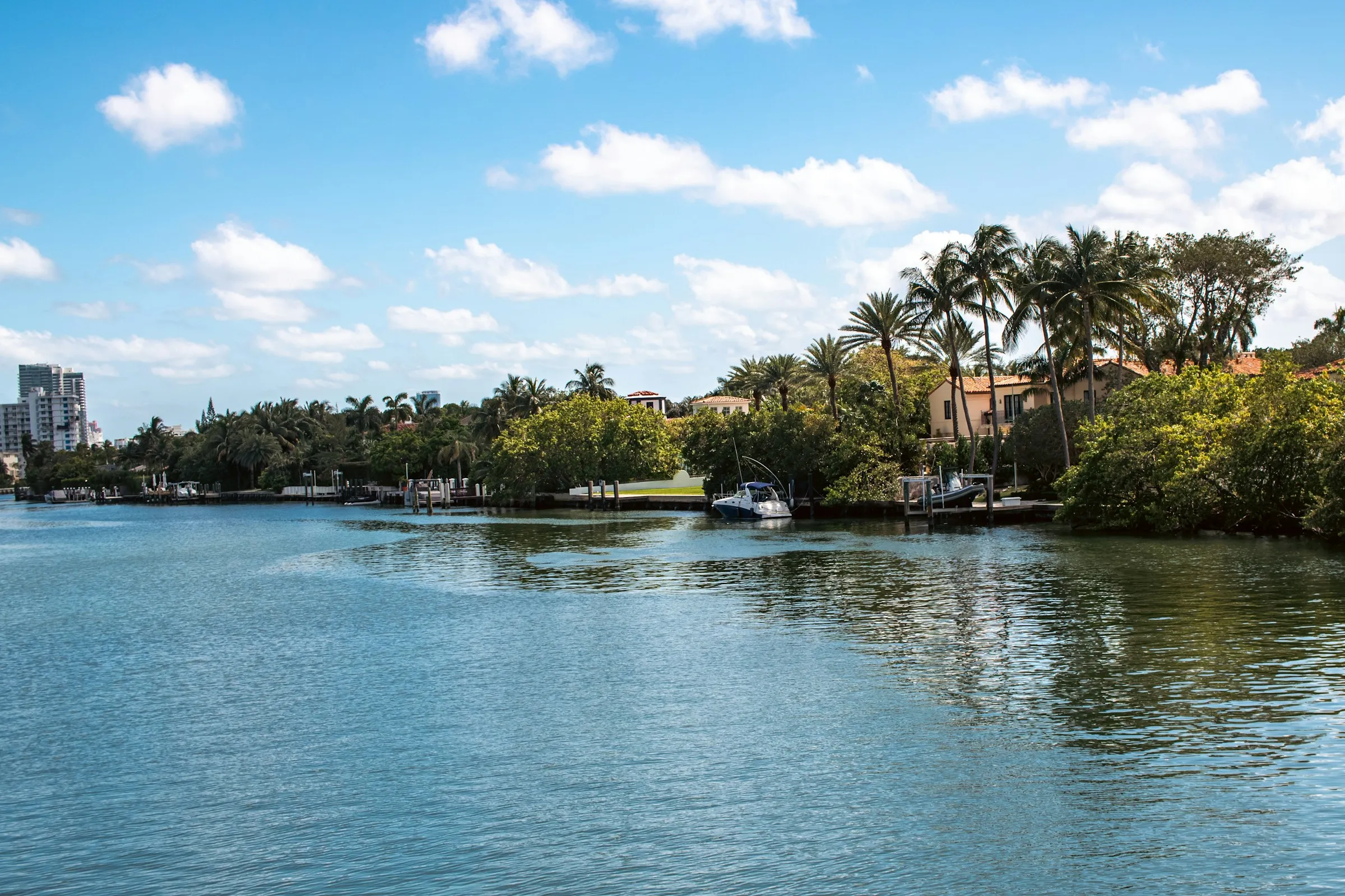 Calm Florida waterway lined with waterfront homes and palm trees